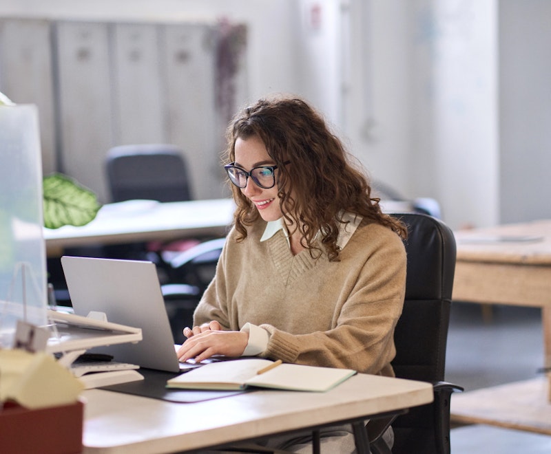 Woman Typing On A Laptop